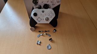 Xbox Elite Series 2 Core review image showing the controller next to a selection of its optional attachments