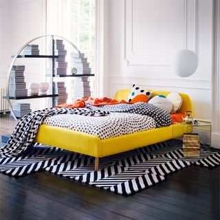 bedroom with white walls and yellow bed