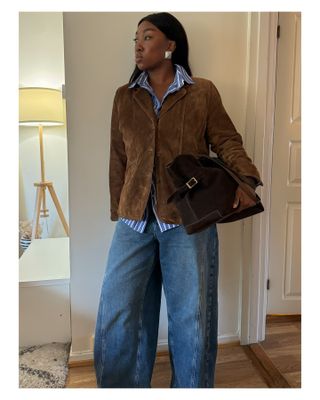 Woman in suede jacket and bag.