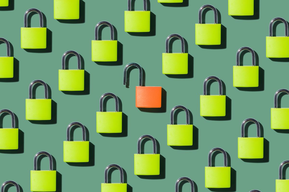 lots of lime-coloured padlocks set against a green background, with one orange padlock in the middle that&#039;s unlocked