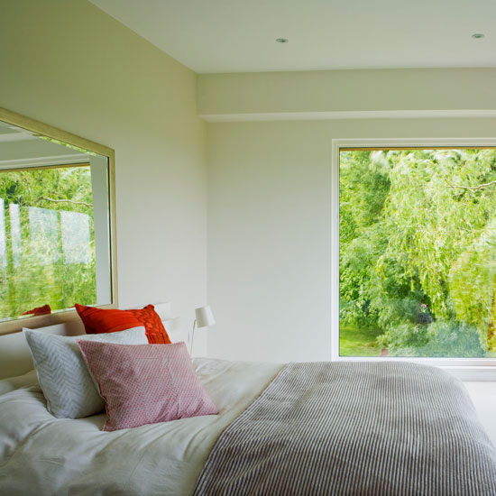 master bedroom with white wall cushions