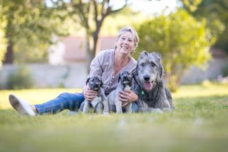 The identical twin puppies, shown here with their owner, Dawn Barnard.