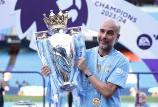 Manchester City manager Pep Guardiola poses with the Premier League trophy, 2024