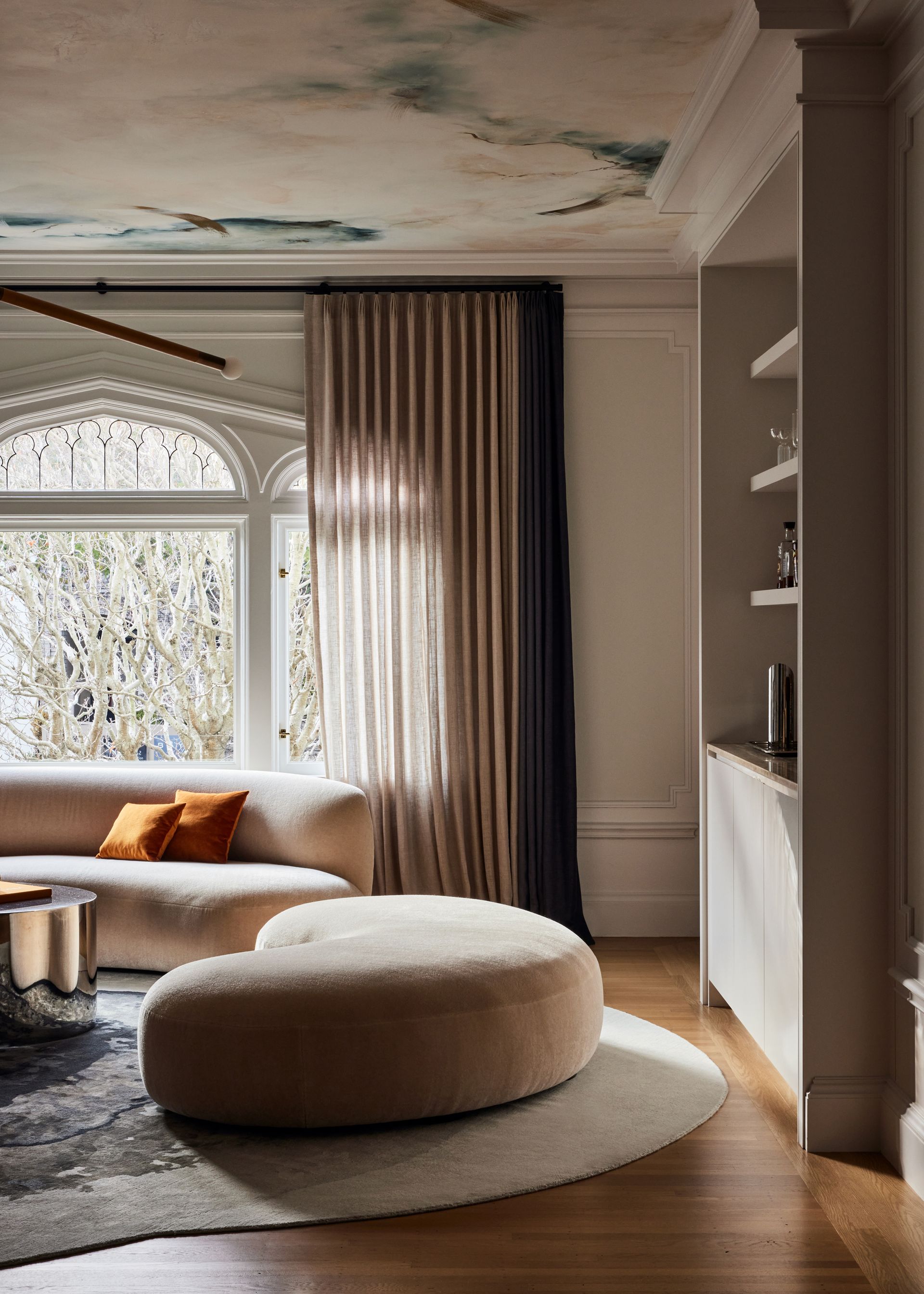 A living room with patterned ceiling