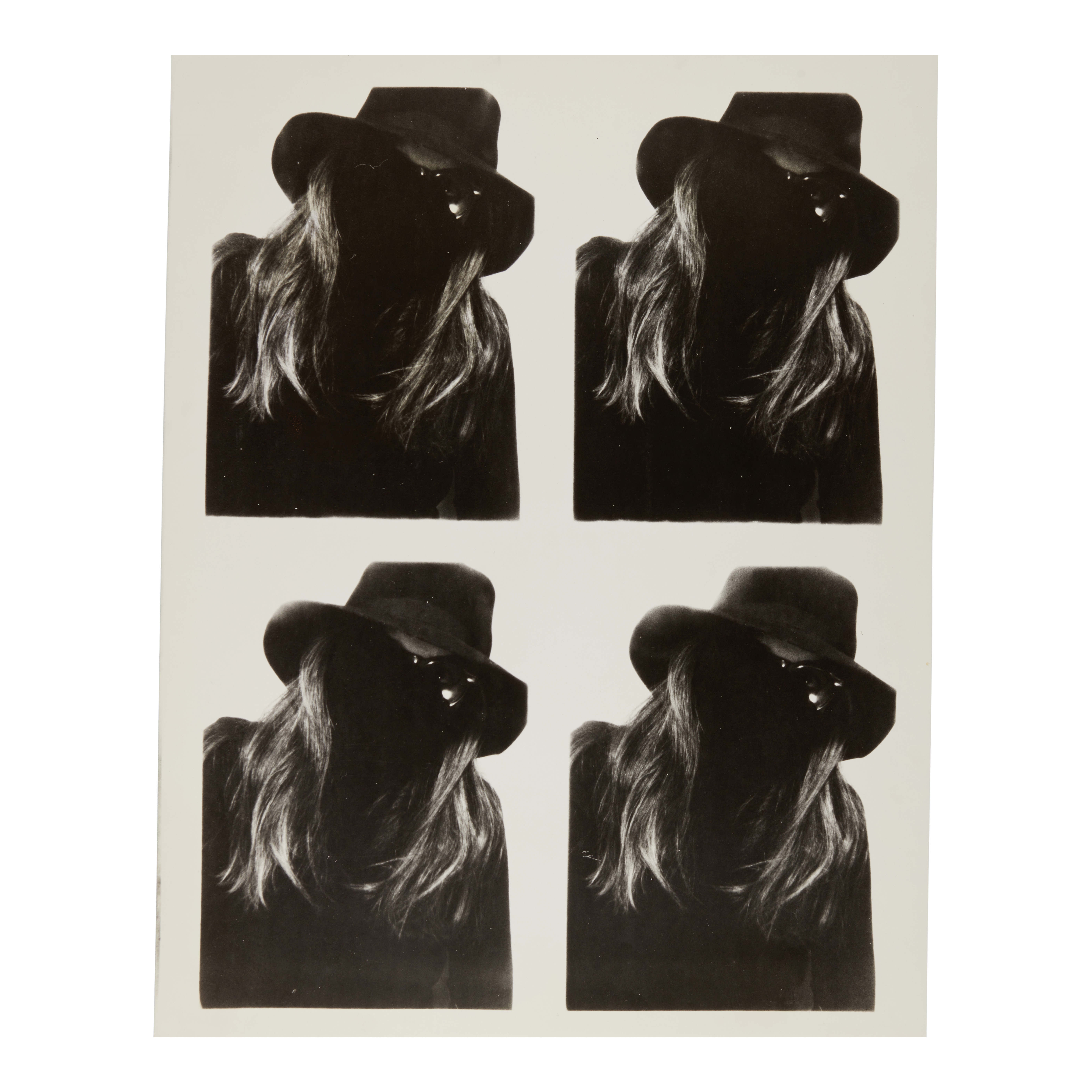 A grid of four near-identical black and white photobooth portraits showing a figure in a wide-brimmed hat with long hair falling across their face, eyes barely visible.