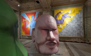 The heads are showcased alongside a series of large ceremonial banners that cover the walls from floor to ceiling