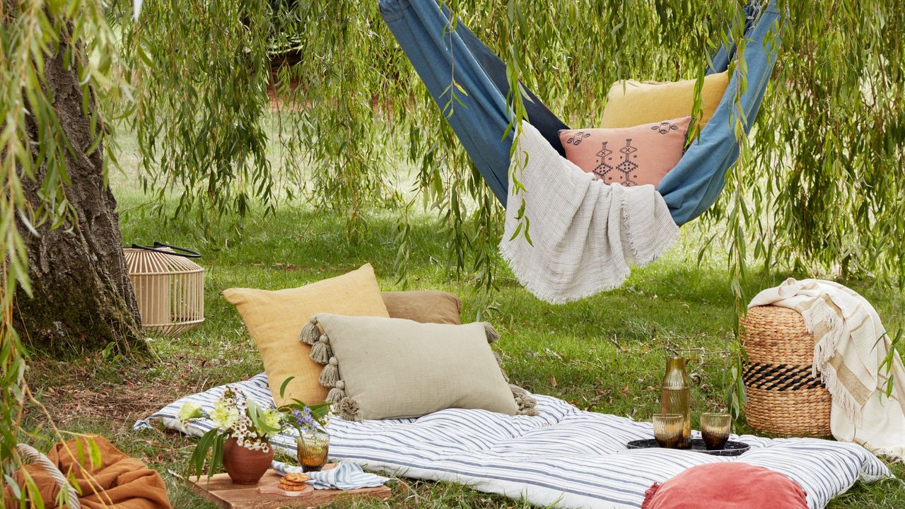 A picnic in the garden with a hammock and cushions