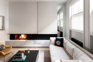 White living room with modern fireplace