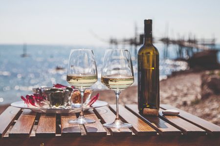 two glasses and a bottle of wine on a table