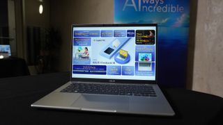 Asus Vivobook 14 on a table with the display on at CES 2025