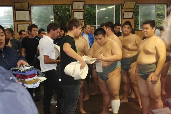 Peter Sagan gets his mawashi signed by a sumo opponent.