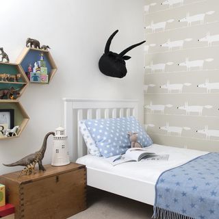 neutral kids bedroom with feature wall and open wall storage boxes