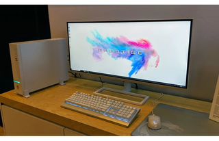 MSI Prestige monitor, keyboard, mouse and desktop.