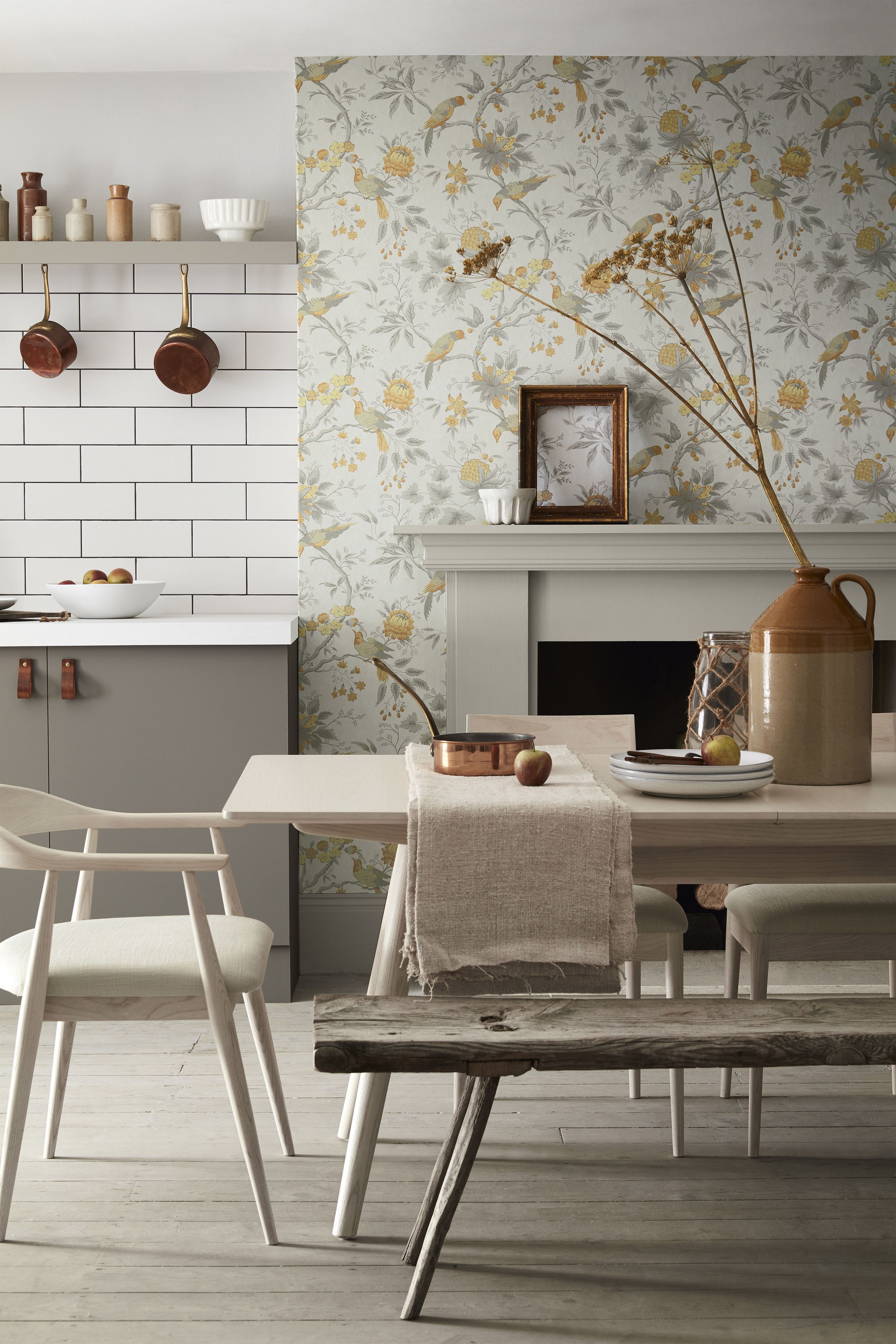 Floral wallpaper in an open plan kitchen with metro tiling contrast