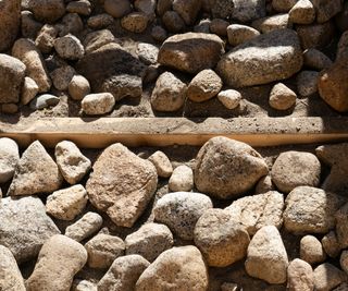 Rubble placed at the base of a raised bed to improve drainage