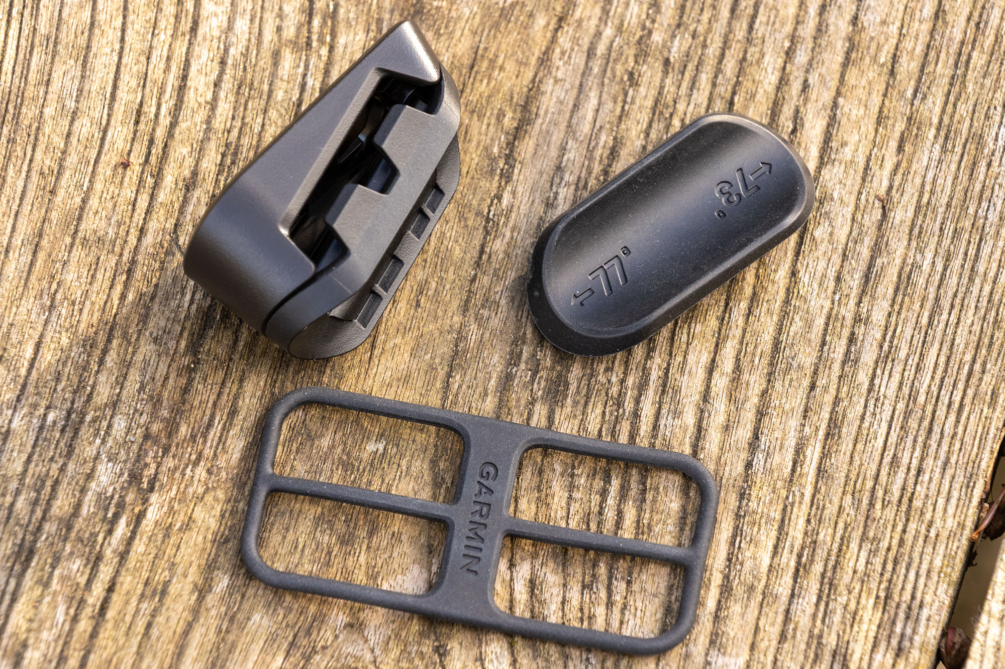 Parts of the Garmin mount, including the revised strap and bushing