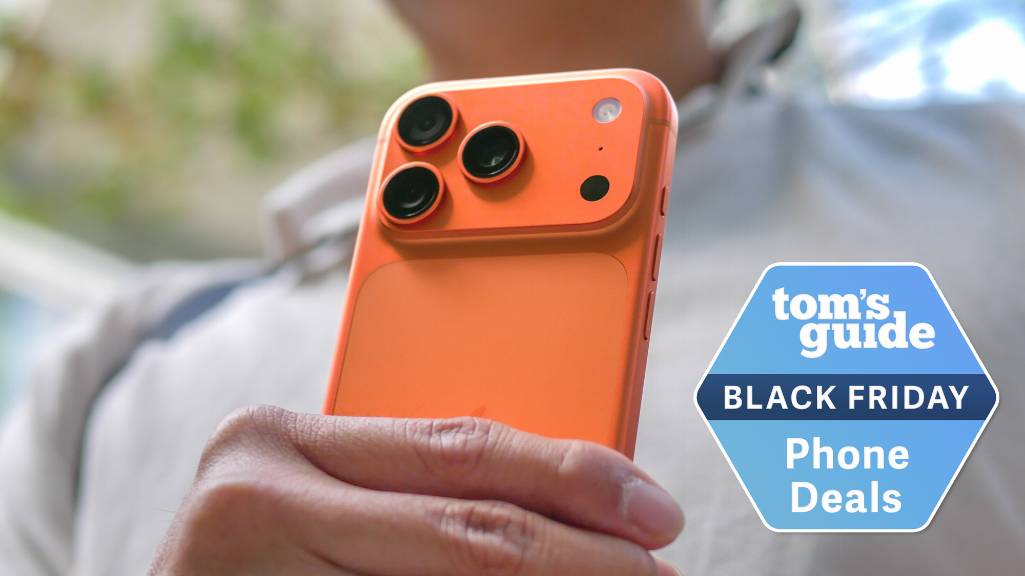 iPhone 17 Pro held in the hand with Black Friday badge nearby.