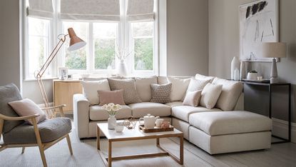beige living room with picture gallery and neutral sofa