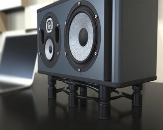 Aperta Series IsoAcoustics speaker isolation on a desk