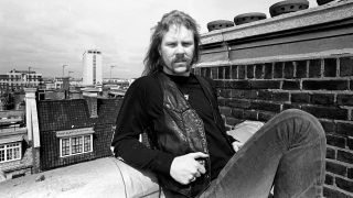 James Hetfield shot on a rooftop in London in black and white, looking serious