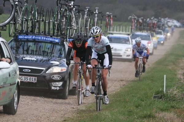Riders battle their way alongside the team cars