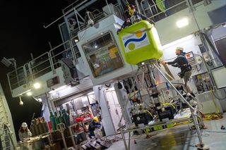 Samples from the Guaymas Basin hydrothermal site are raised to the deck of the Falkor.