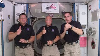 NASA astronauts Bob Behnken (left), Doug Hurley (center) and Chris Cassidy speak with reporters from the International Space Station on June 1, 2020.