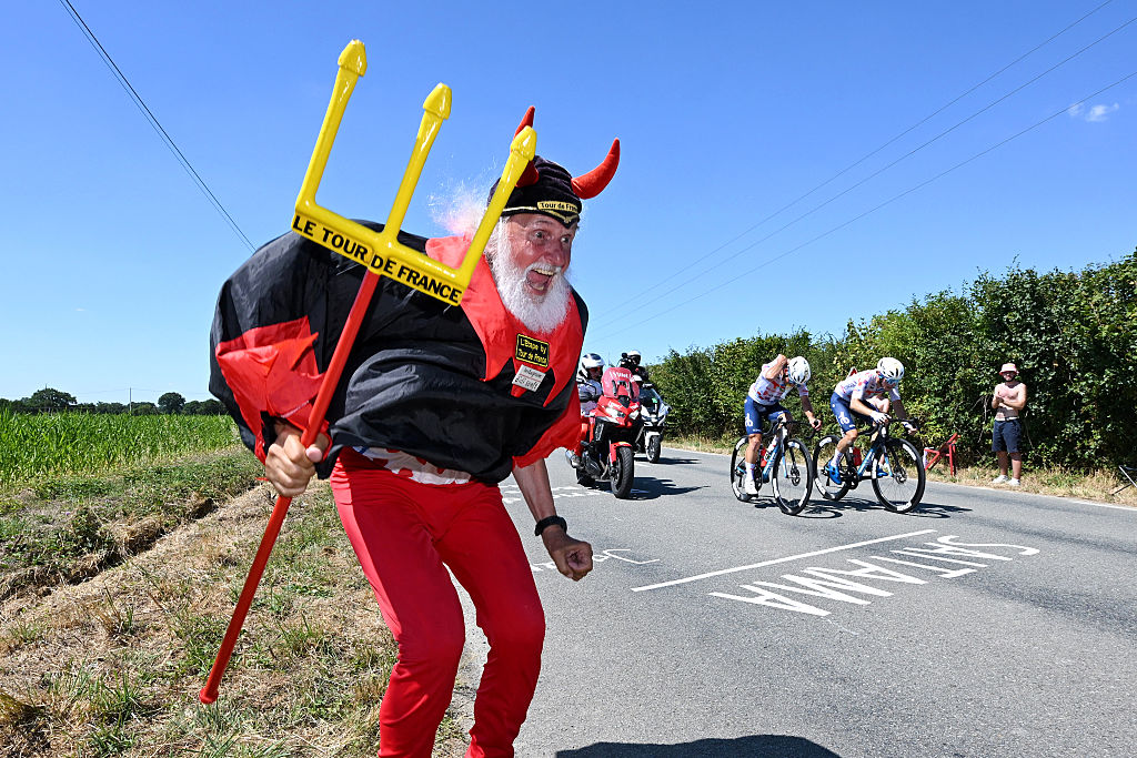 LAVAL, FRANCE - JULY 12: Mathieu Burgaudeau of France and Matteo Vercher of France and Team TotalEnergies compete in the breakaway while Didi Senft of Germany (Devil - Didi Devil) cheers during the 112th Tour de France, Stage 8 a 197km stage from Saint-Meen-le-Grand to Laval (Espace Mayenne) / #UCIWT / on July 12, 2025 in Laval, France.