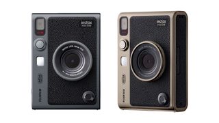 Two Instax Mini Evo cameras, side by side, in Dark Silver and Titanium Gold, against a white background