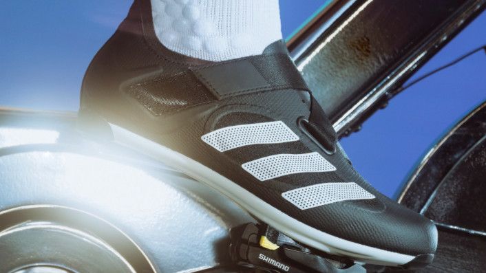 Person&#039;s foot wearing Adidas The Indoor Cycling Shoe clipped into spin bike pedal