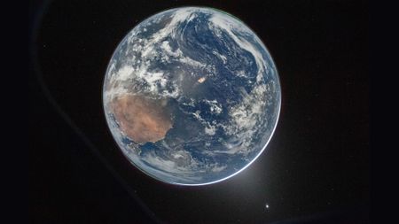A view of Earth with a glow behind it.