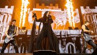 A singer on stage, with fire