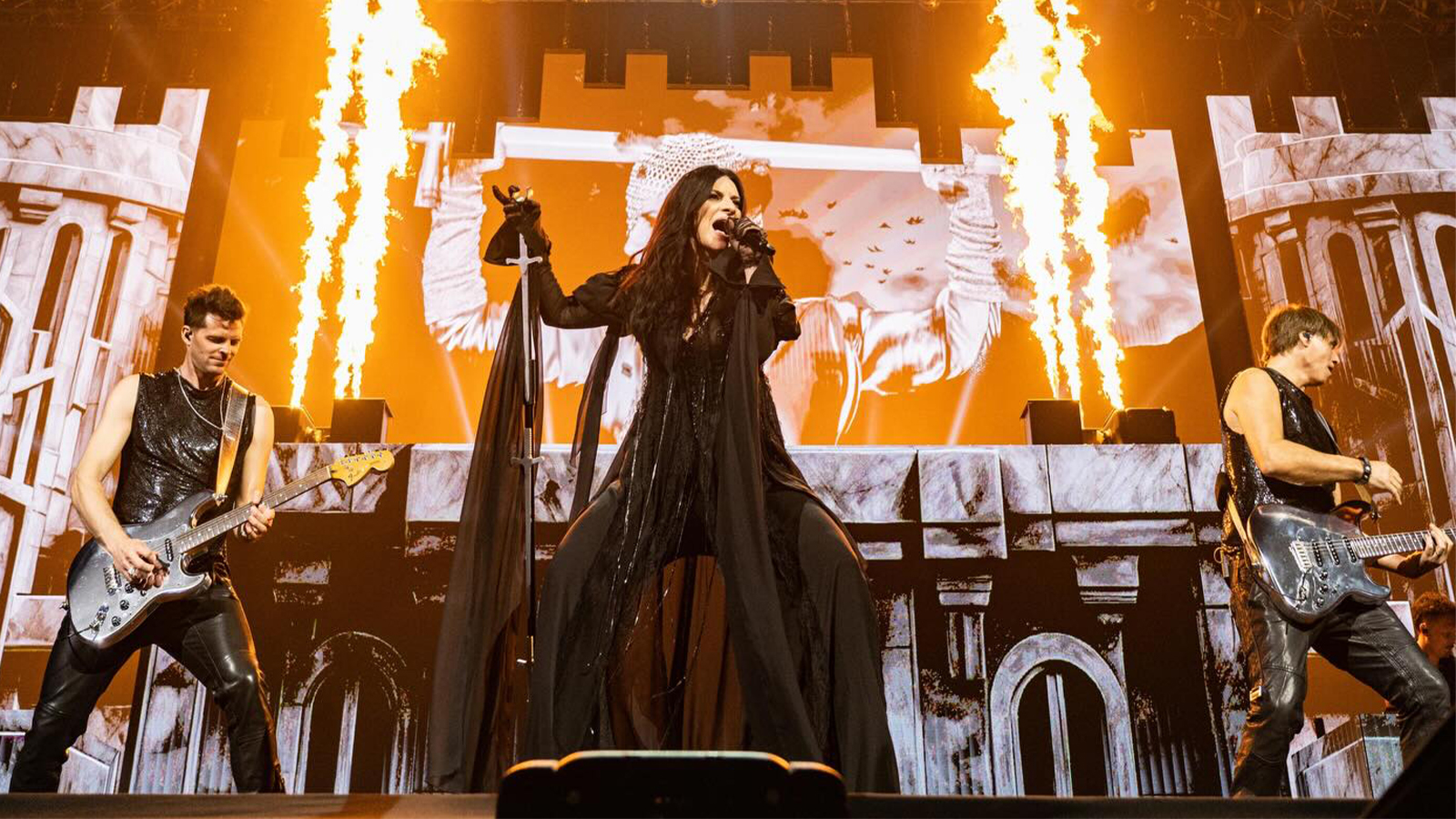 A singer on stage, with fire