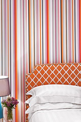 bedroom-walls-with-stripes-of-purple-orange-and-pink-and-orange-headbaord