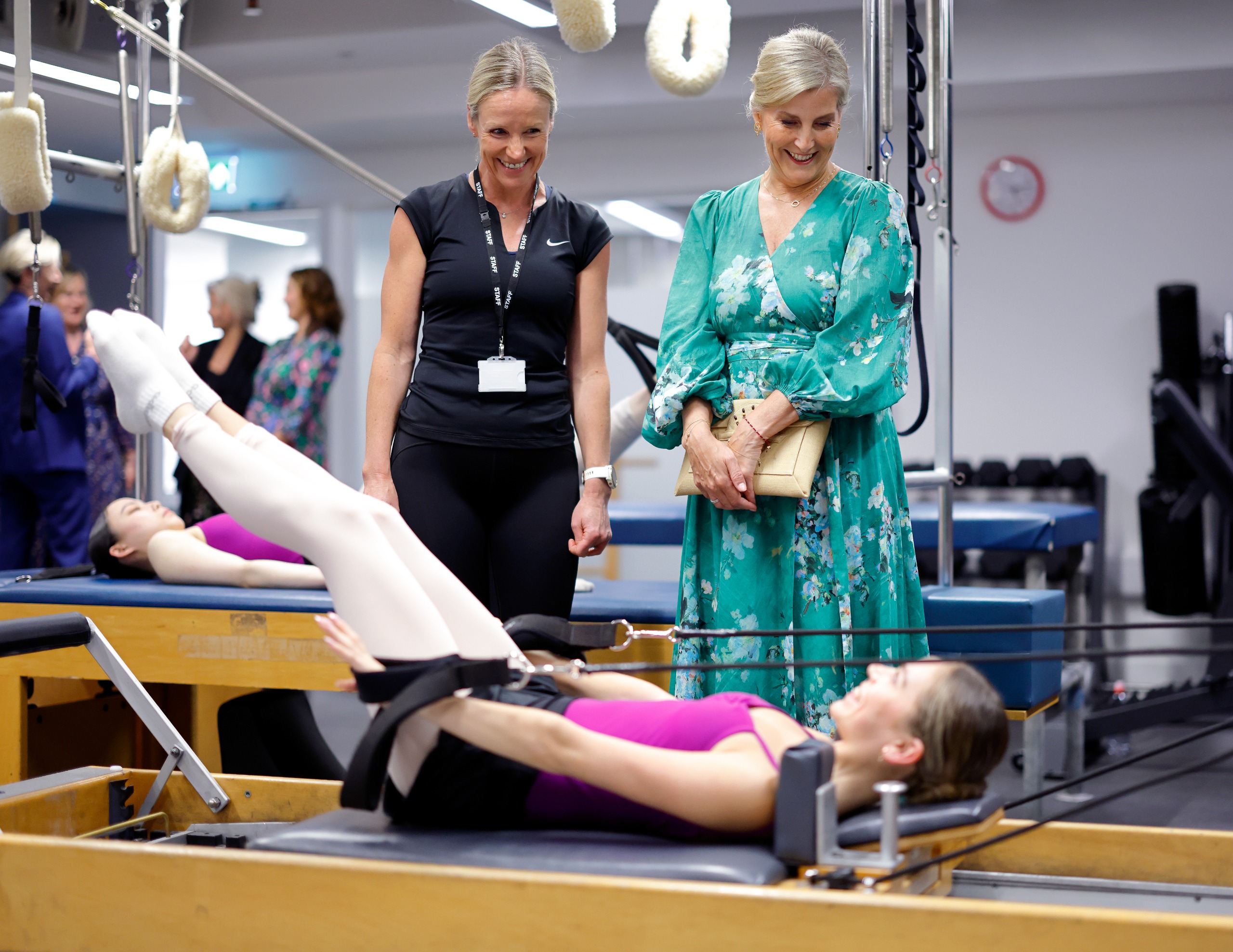Duchess Sophie watching a ballerina use a reformer pilates machine