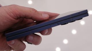 Samsung Galaxy Z Fold 6 in navy blue held above a table