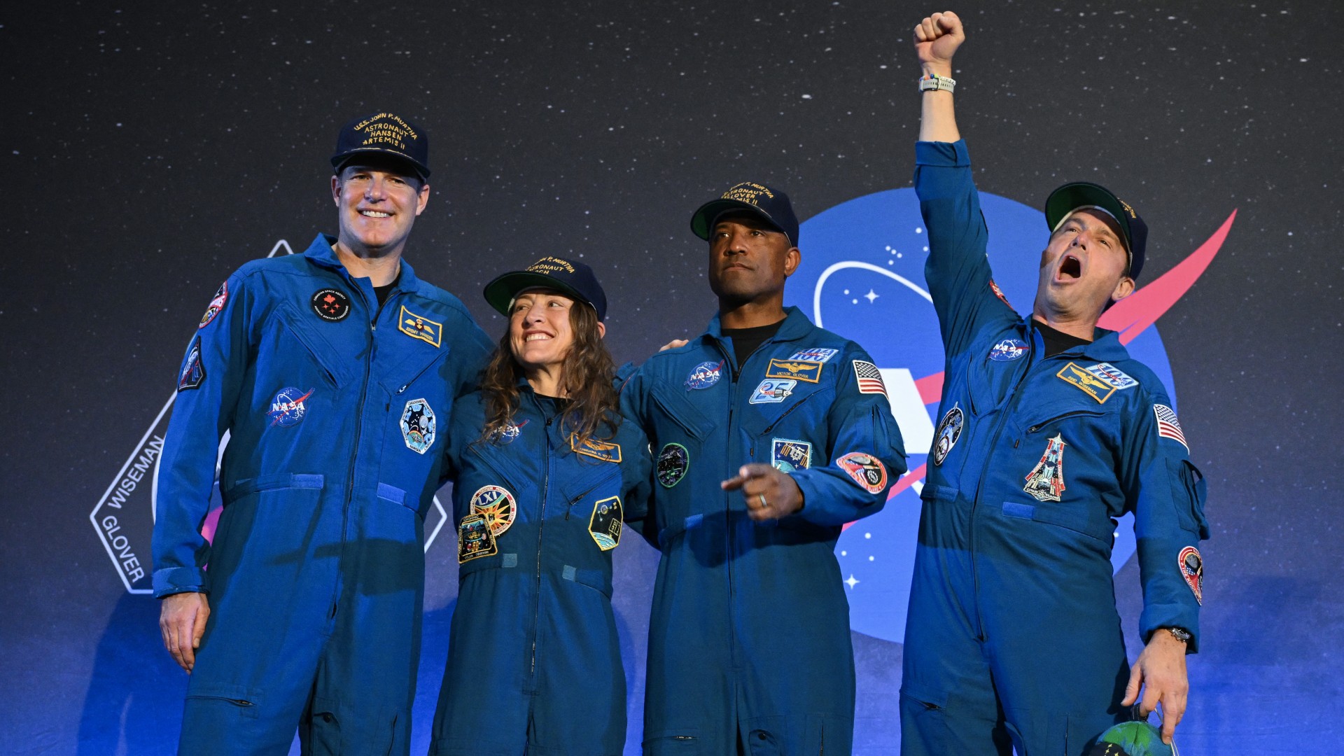 NASA's Artemis II mission astronauts react during a welcoming ceremony at Ellington Field Joint Reserve Base in Houston, Texas