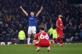 LIVERPOOL, ENGLAND - FEBRUARY 12: James Tarkowski of Everton celebrates after his equalising goal stands following a VAR review as Trent Alexander-Arnold and Mohamed Salah of Liverpool look dejected during the Premier League match between Everton FC and Liverpool FC at Goodison Park on February 12, 2025 in Liverpool, England. (Photo by Carl Recine/Getty Images)