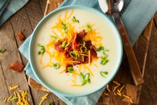 Potato soup with cheese and bacon topping