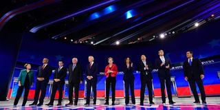 A group of politicians stand on a stage.