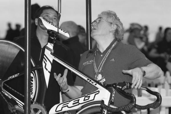 UCI judges weighing and measuring bikes before the race.
