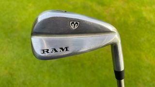 Ram FX77 Iron held aloft to reveal its wide sole and excellent stainless steel clubhead