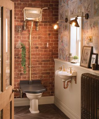 downstairs toilet with brick wall and gold effect toilet cistern