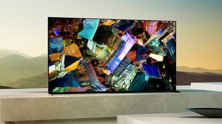 The Sony Z9K 8K TV displaying colorful geometric shapes in front of a mountainous landscape