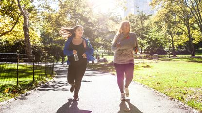 Two women running in activewear at Central Park, New York