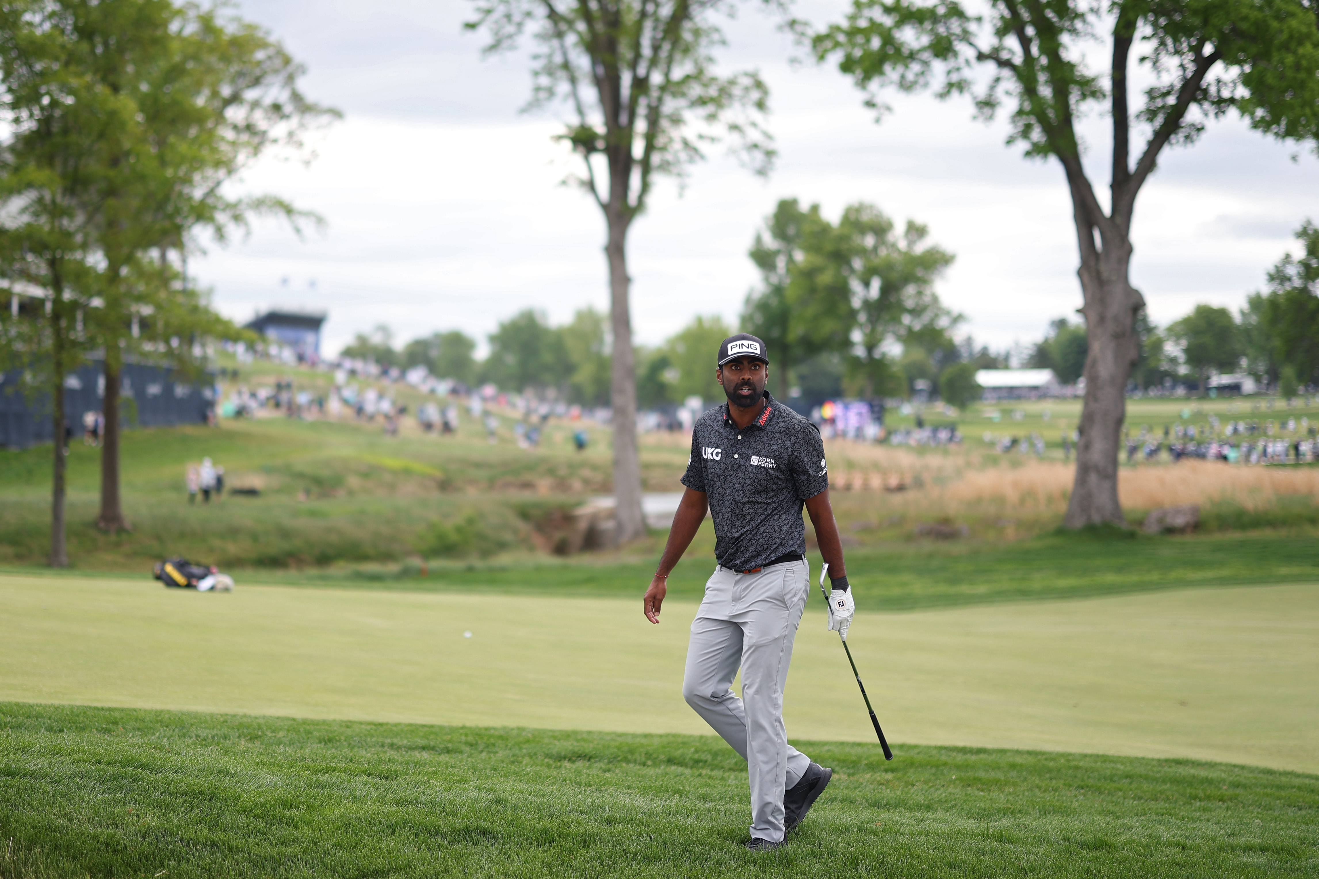 Sahith Theegala looks for his ball on the ninth hole during the second round of the PGA Championship at Aronimink Golf Club