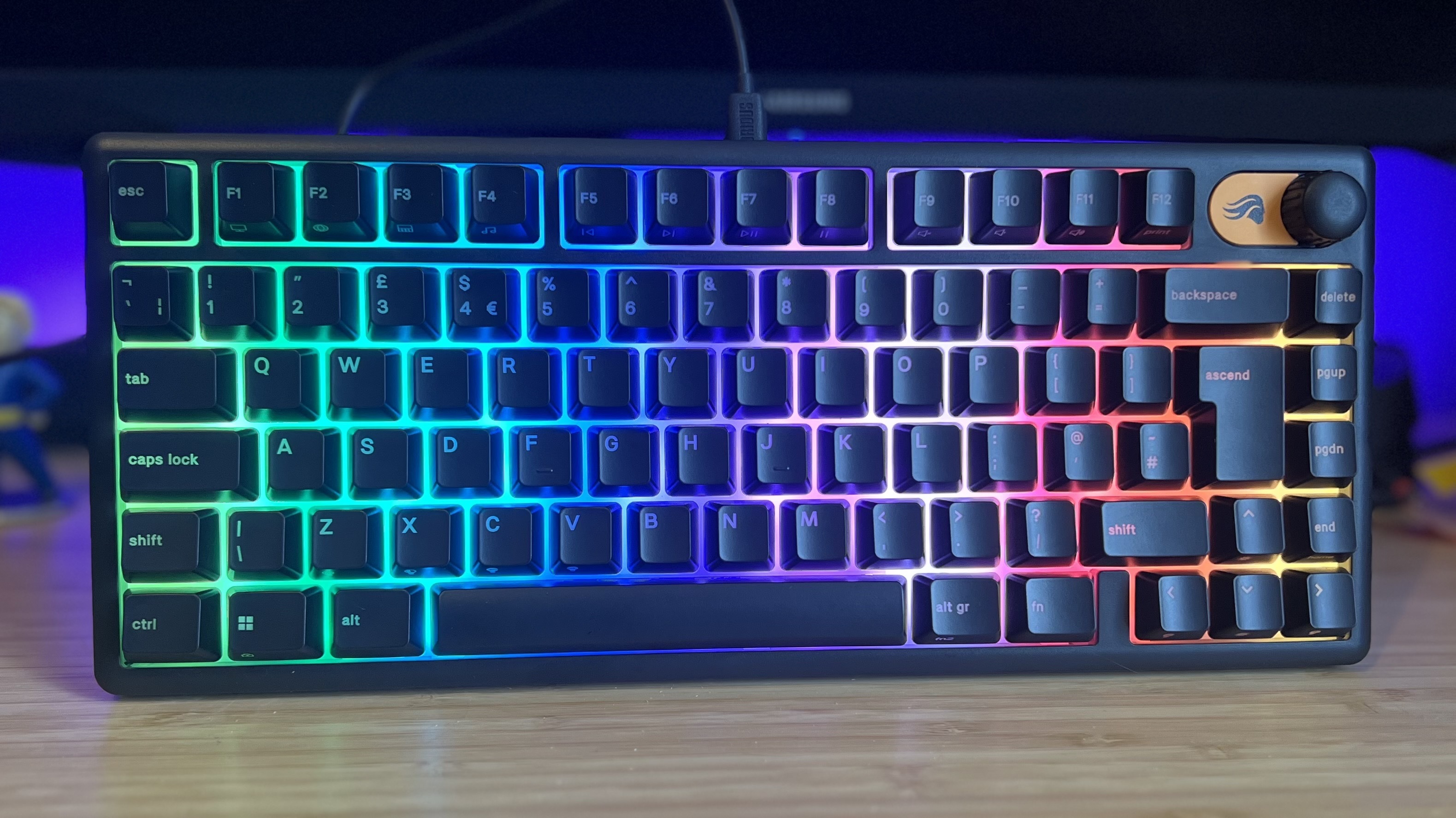 Glorious GMBK 75% gaming keyboard standing upright on wooden desk
