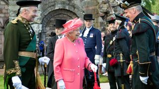 Britain's Queen Elizabeth II (C) attends a garden party at the Palace of Holyroodhouse in Edinburgh on July 3, 2019 Britain's Queen Elizabeth II attends a garden party at the Palace of Holyroodhouse in Edinburgh on July 3, 2019.