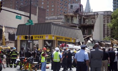 Rescue workers search for victims after a building at a demolition site collapsed in an apparent accident on June 5 in Philadelphia. 