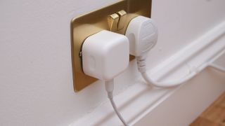 Apple 20W wall charger in a plug socket